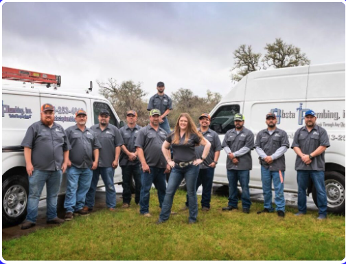 The Obsta Plumbing team standing in front of their service vans